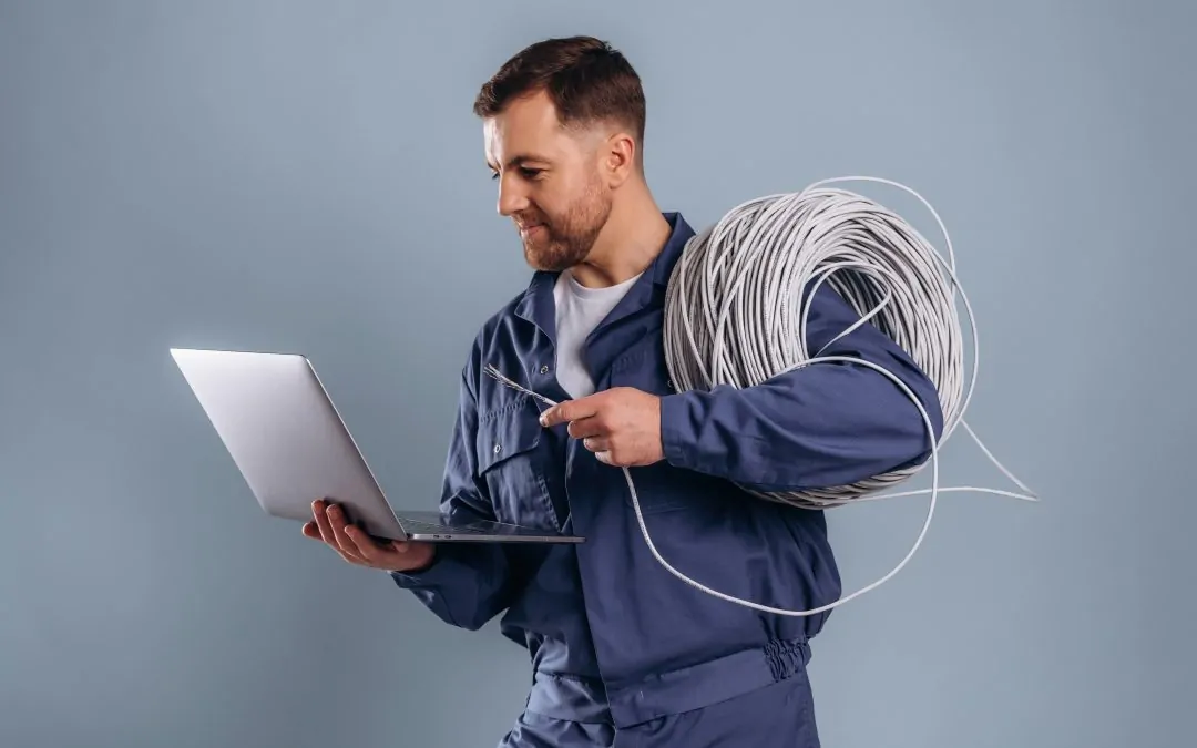 Laptop and internet cables, worker.